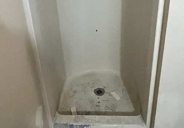 Before shower reglazing showing restored shine and smooth surface