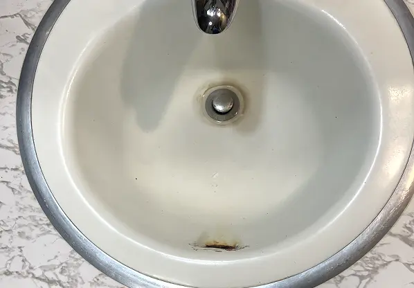 Before comparison of sink reglazing showing flawless transformation